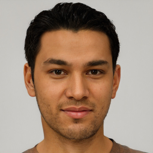 Joyful latino young-adult male with short  black hair and brown eyes