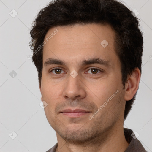 Joyful white adult male with short  brown hair and brown eyes