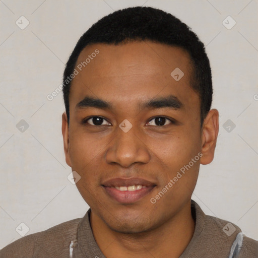 Joyful black young-adult male with short  black hair and brown eyes