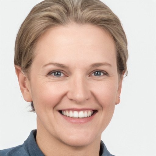 Joyful white adult female with short  brown hair and grey eyes