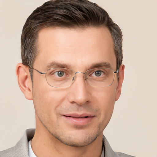 Joyful white adult male with short  brown hair and brown eyes