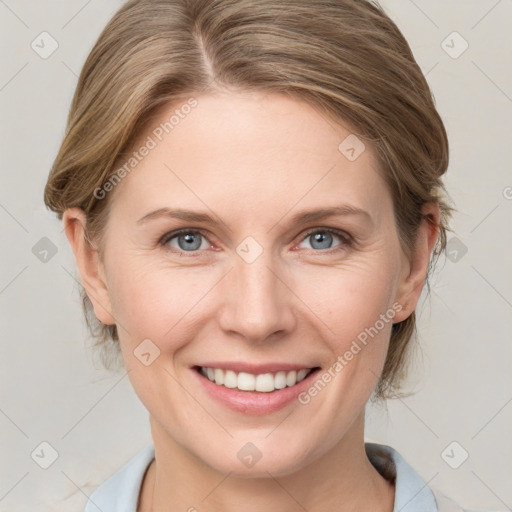 Joyful white young-adult female with medium  brown hair and blue eyes