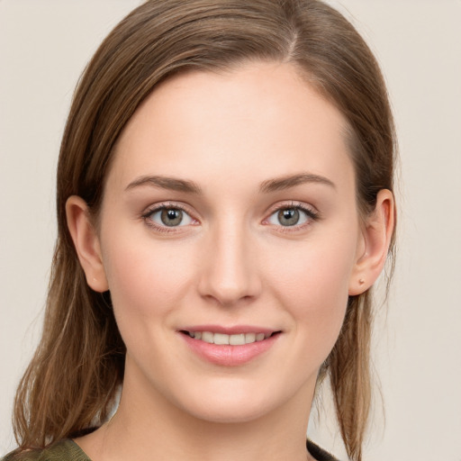 Joyful white young-adult female with medium  brown hair and blue eyes