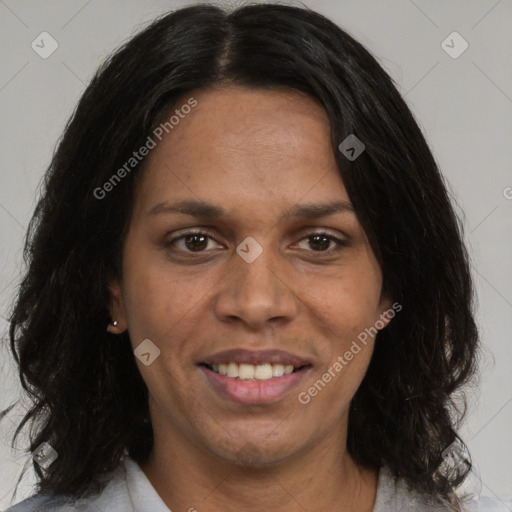 Joyful black adult female with medium  brown hair and brown eyes