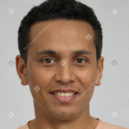 Joyful latino young-adult male with short  brown hair and brown eyes