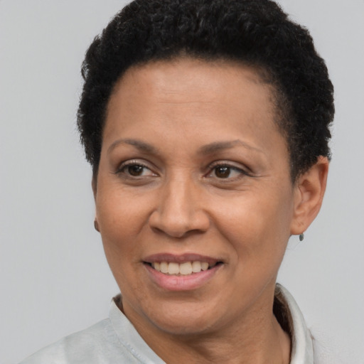Joyful latino adult female with short  brown hair and brown eyes
