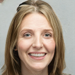 Joyful white young-adult female with long  brown hair and green eyes