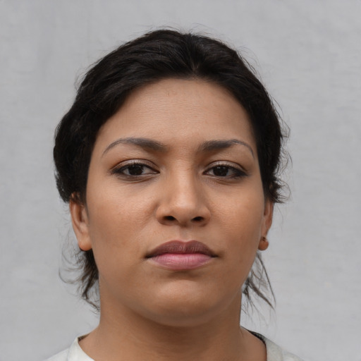 Joyful asian young-adult female with medium  brown hair and brown eyes