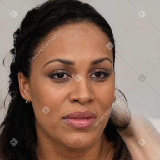 Joyful black adult female with long  brown hair and brown eyes