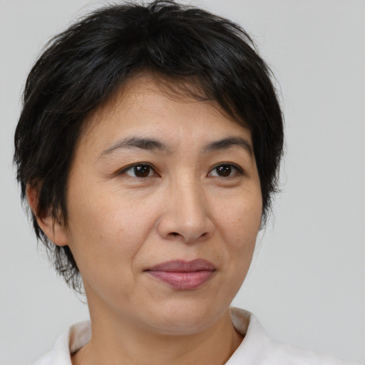 Joyful asian adult female with medium  brown hair and brown eyes