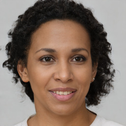 Joyful black adult female with short  brown hair and brown eyes