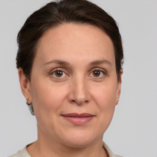 Joyful white adult female with short  brown hair and grey eyes