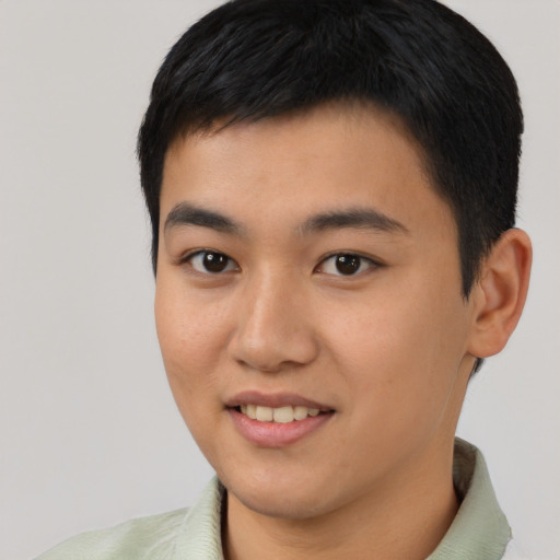 Joyful asian young-adult male with short  black hair and brown eyes