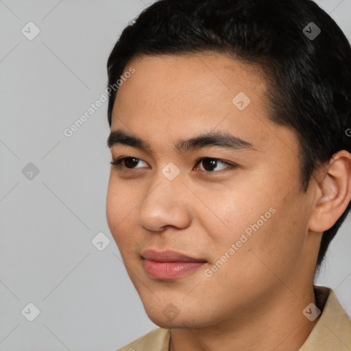 Joyful asian young-adult male with short  black hair and brown eyes