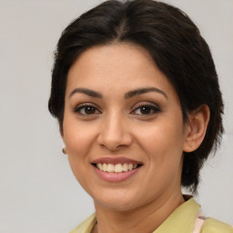 Joyful latino young-adult female with medium  brown hair and brown eyes