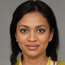 Joyful black young-adult female with medium  brown hair and brown eyes