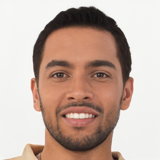 Joyful latino young-adult male with short  black hair and brown eyes