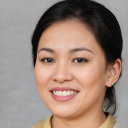 Joyful asian young-adult female with medium  brown hair and brown eyes