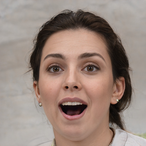 Joyful white adult female with medium  brown hair and brown eyes