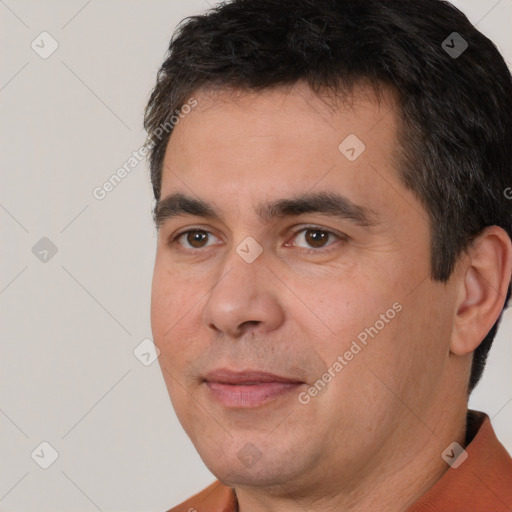 Joyful white adult male with short  black hair and brown eyes