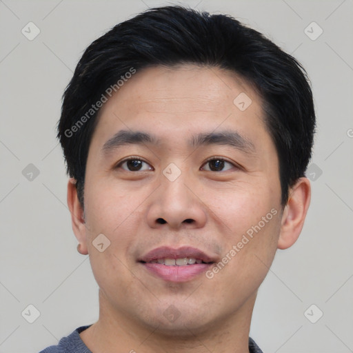 Joyful asian young-adult male with short  black hair and brown eyes