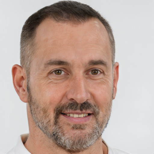 Joyful white adult male with short  brown hair and brown eyes