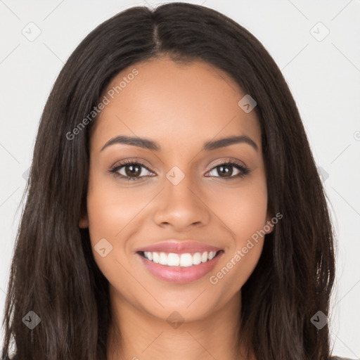 Joyful latino young-adult female with long  brown hair and brown eyes