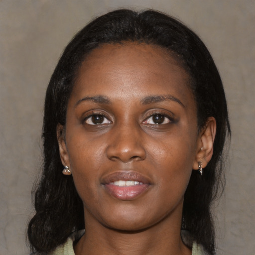 Joyful black young-adult female with medium  black hair and brown eyes