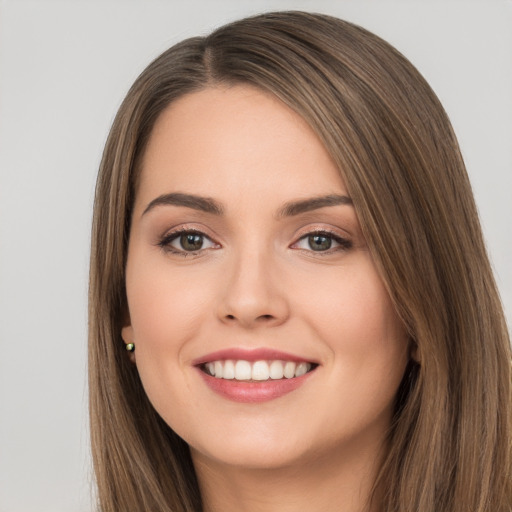 Joyful white young-adult female with long  brown hair and brown eyes