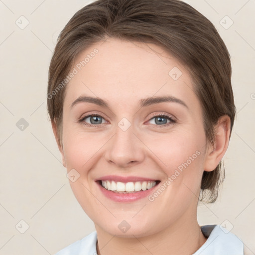 Joyful white young-adult female with medium  brown hair and green eyes