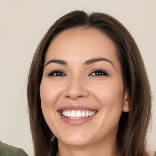 Joyful white young-adult female with long  brown hair and brown eyes