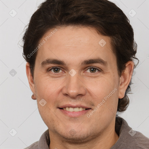 Joyful white adult male with short  brown hair and brown eyes