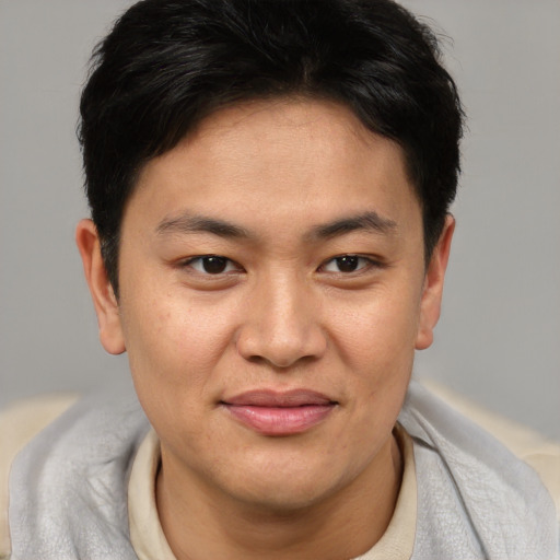 Joyful asian young-adult male with short  brown hair and brown eyes