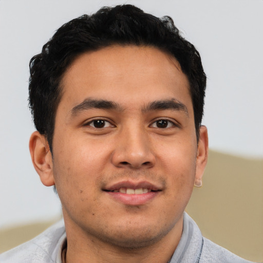 Joyful asian young-adult male with short  brown hair and brown eyes