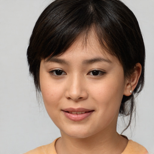 Joyful asian young-adult female with medium  brown hair and brown eyes