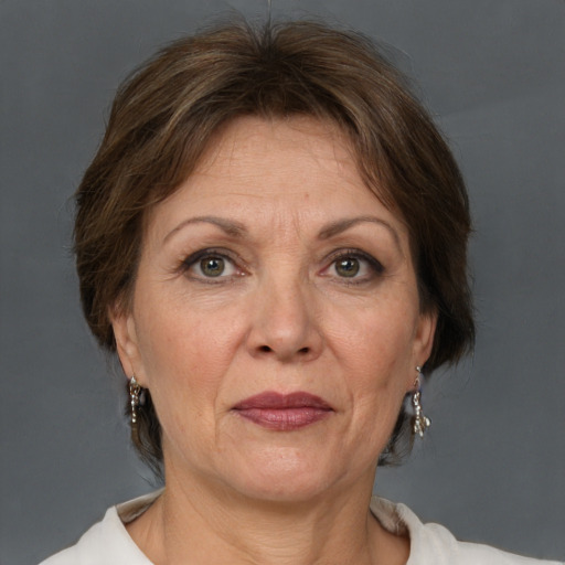 Joyful white adult female with short  brown hair and grey eyes