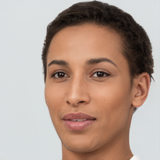 Joyful latino young-adult female with short  brown hair and brown eyes