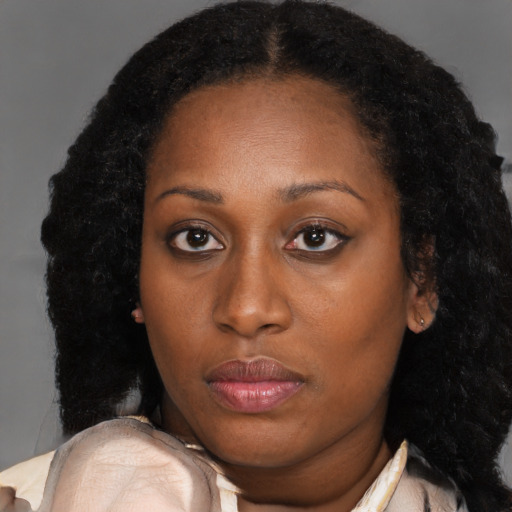 Neutral black young-adult female with long  brown hair and brown eyes