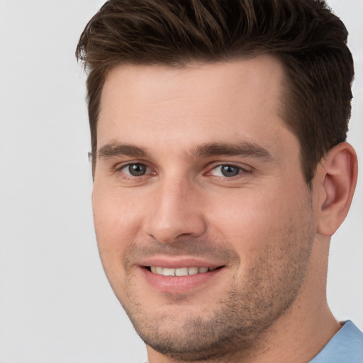 Joyful white young-adult male with short  brown hair and brown eyes