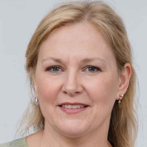 Joyful white adult female with medium  brown hair and grey eyes