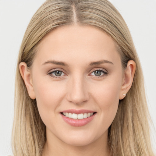 Joyful white young-adult female with long  brown hair and grey eyes