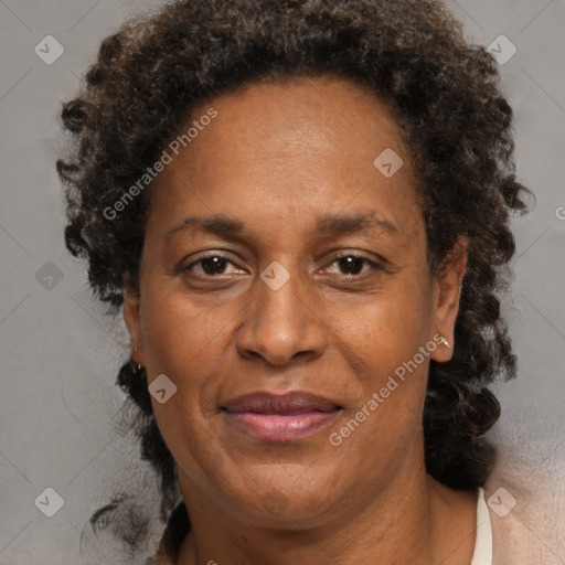 Joyful black adult female with medium  brown hair and brown eyes