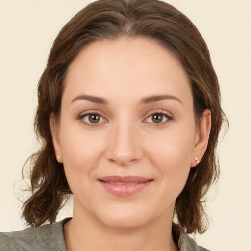 Joyful white young-adult female with medium  brown hair and green eyes