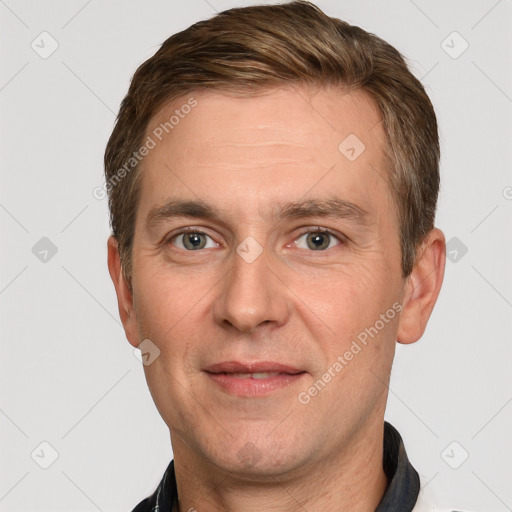 Joyful white adult male with short  brown hair and grey eyes