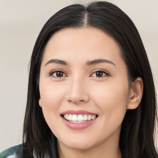 Joyful white young-adult female with long  black hair and brown eyes