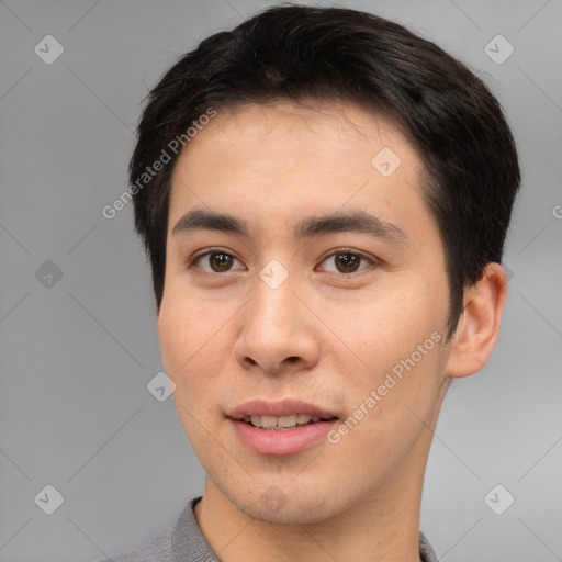 Joyful asian young-adult male with short  brown hair and brown eyes