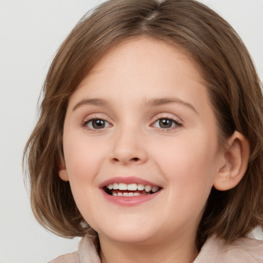 Joyful white child female with medium  brown hair and brown eyes