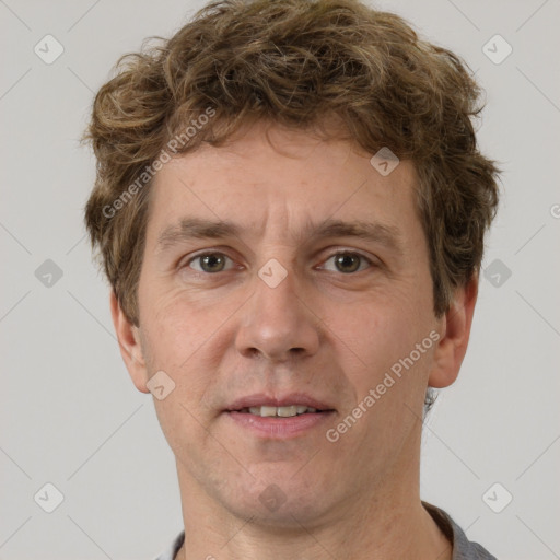 Joyful white adult male with short  brown hair and grey eyes