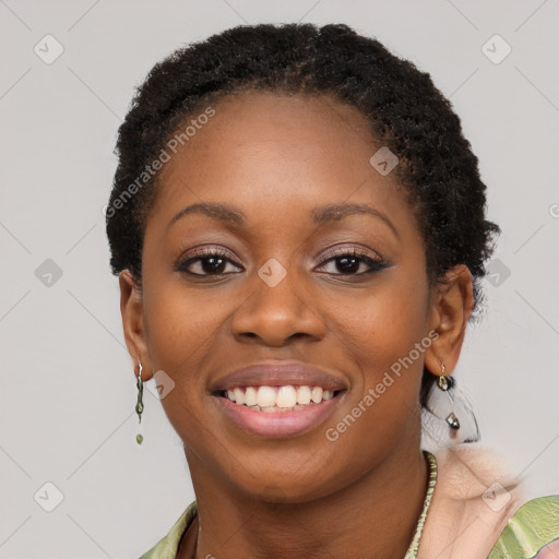 Joyful black young-adult female with short  brown hair and brown eyes