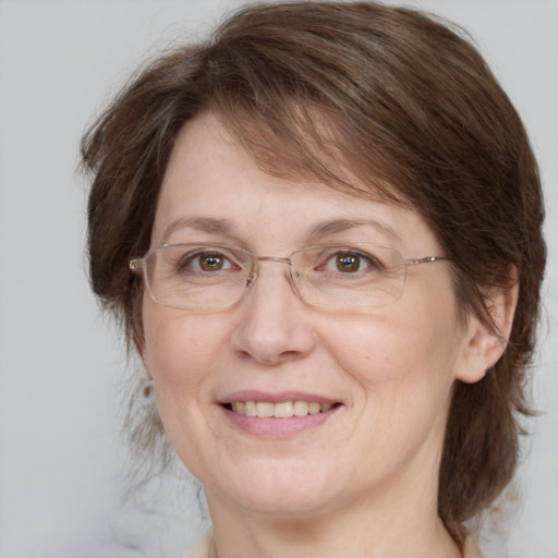 Joyful white adult female with medium  brown hair and grey eyes